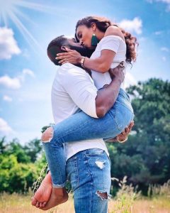 a deep kiss while the man carries her like a baby with eyes closed - instagram