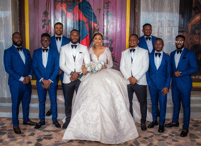 asastan white wedding photo styles 29 - couple and men on suit posing in grand styles